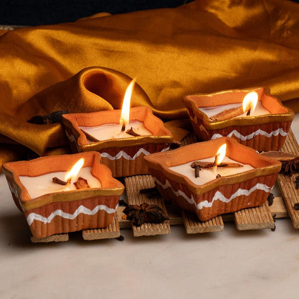 Buy Nura Handpainted Orange Scented Candle - Set Of Four Candles from Vaaree