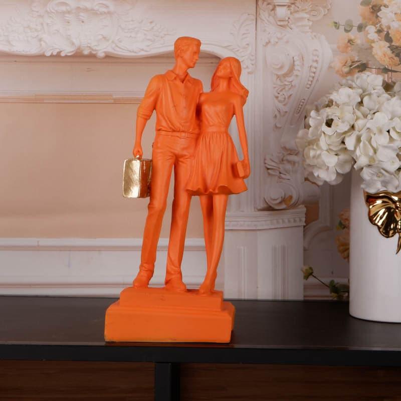 Buy Let's Go Shopping Couple Showpiece - Orange Showpieces from Vaaree