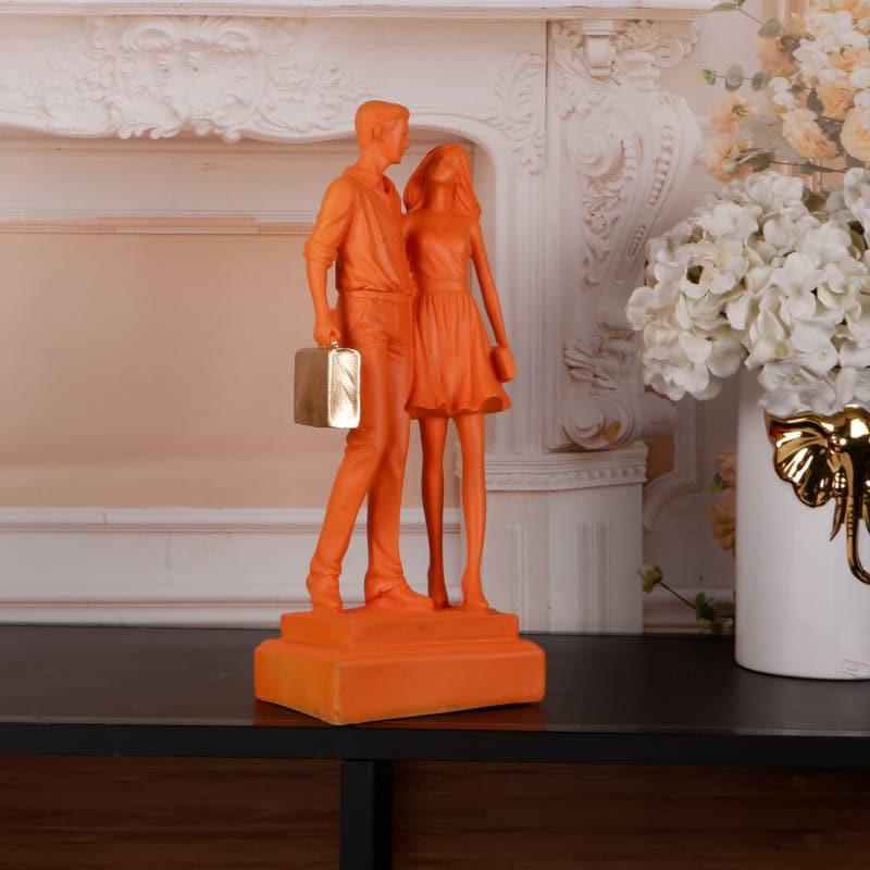 Buy Let's Go Shopping Couple Showpiece - Orange Showpieces from Vaaree