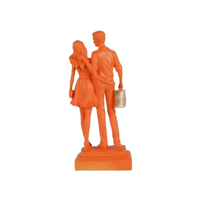 Buy Let's Go Shopping Couple Showpiece - Orange Showpieces from Vaaree